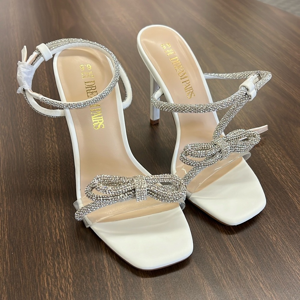 White sandal heels with silver strap and bow